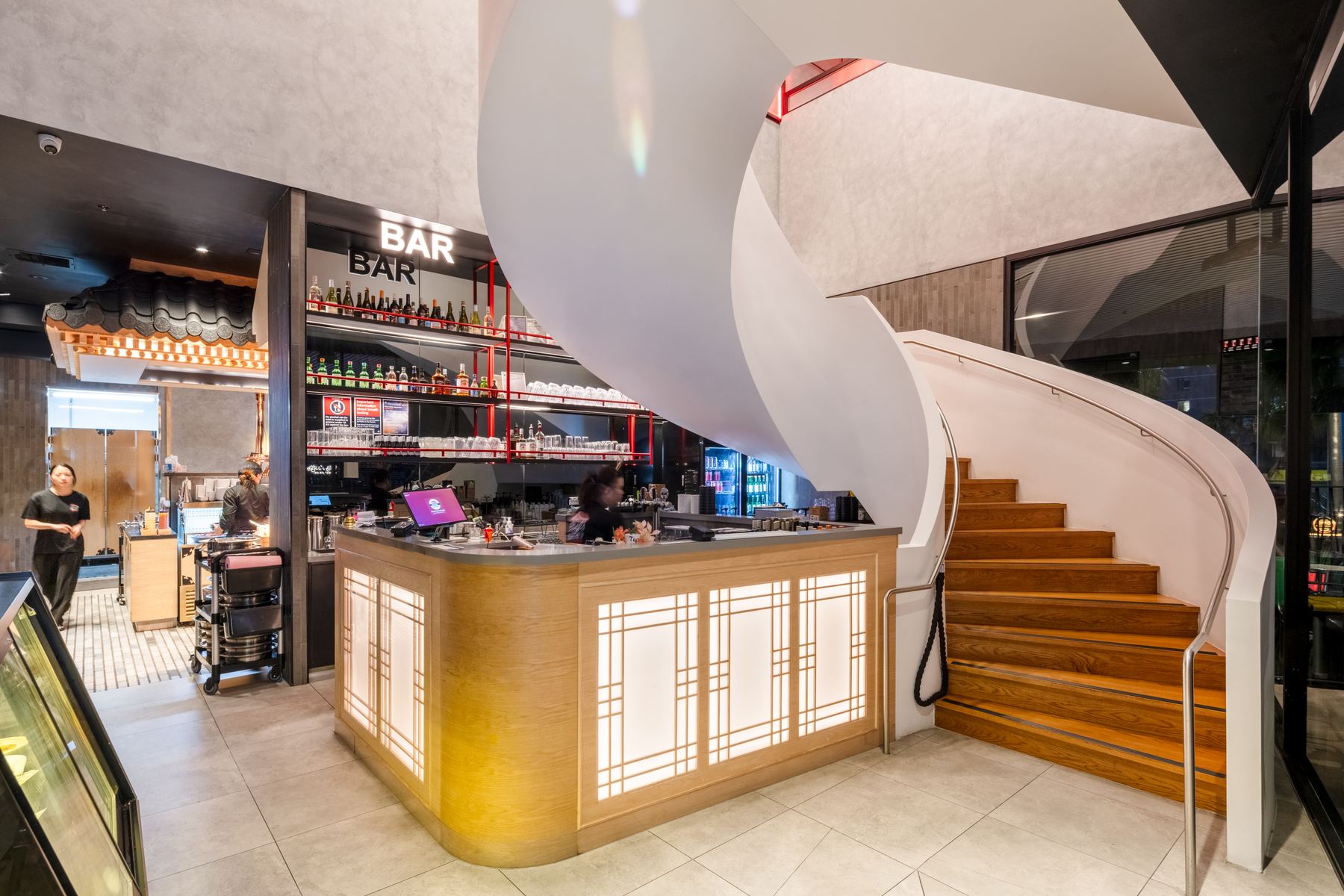 Finished bar and curved timber stair from a Ggreen hospitality fit-out